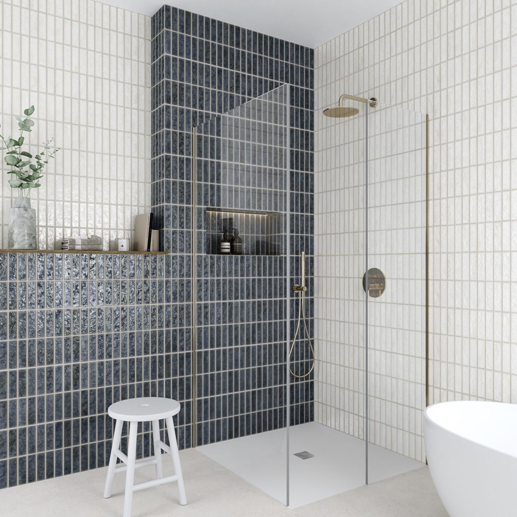 Modern bathroom with blue tiled wall, shower area, and white bathtub.