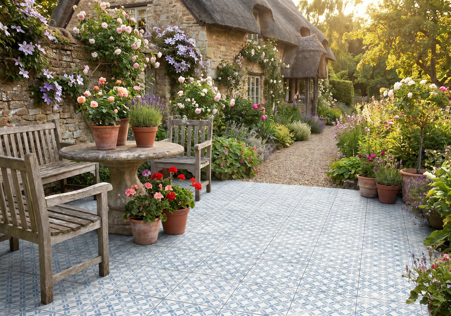 Garden scene with a stone patio, wooden chairs, and potted plants.