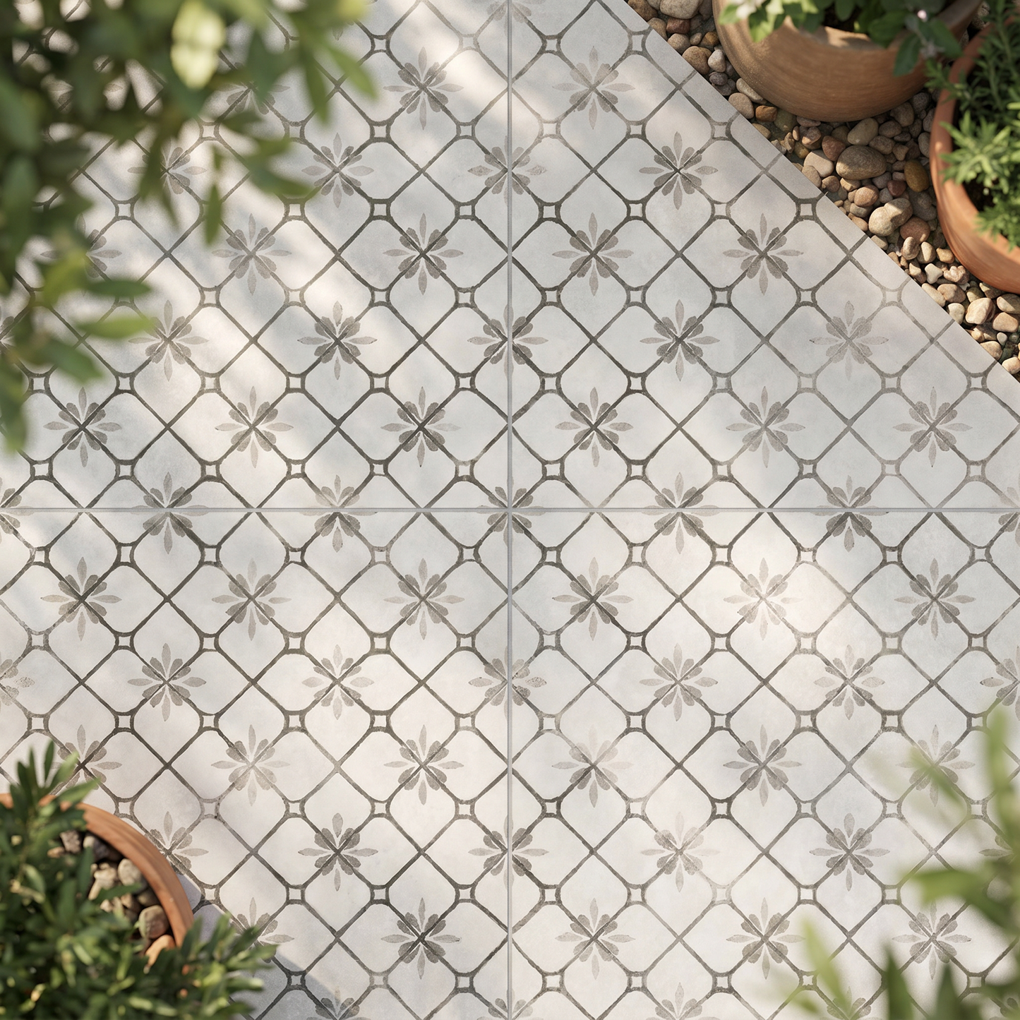 Decorative tile with geometric pattern on a patio surrounded by plants