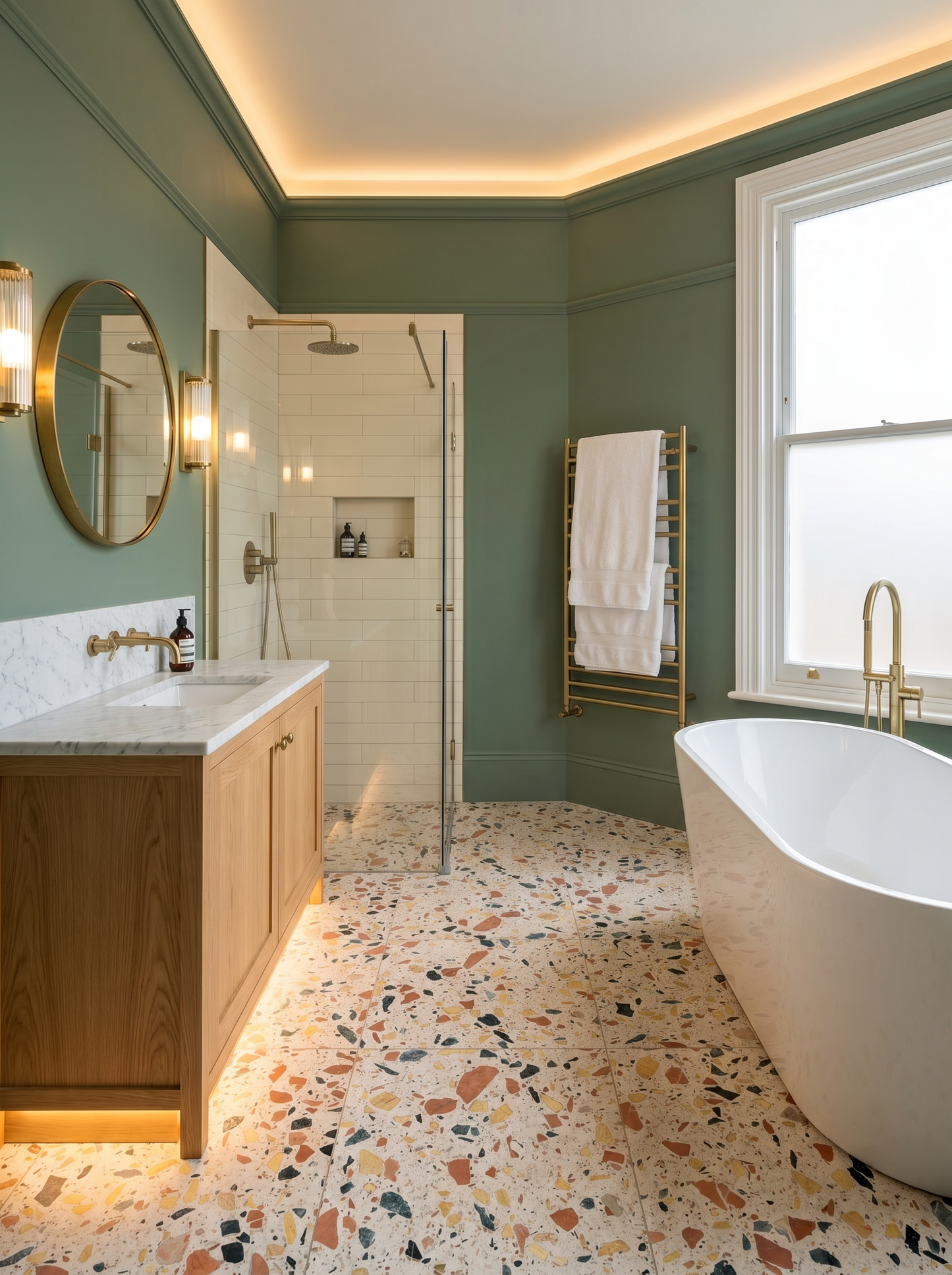 Modern bathroom with freestanding bathtub, terrazzo flooring, and green walls.